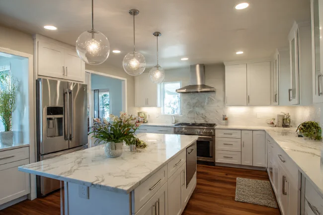 Alexander Home Improvement - Modern kitchen with sleek countertops, high-end appliances, and stylish design.