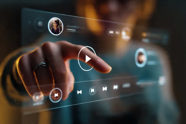 video&a: A person interacting with a futuristic video player interface, tapping a play button on a transparent touchscreen with interactive elements.